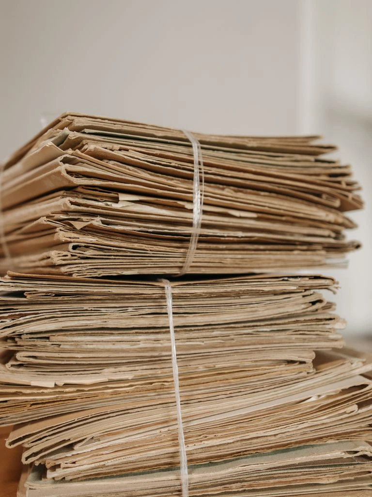 Legal documents tied with red ribbon on a desk